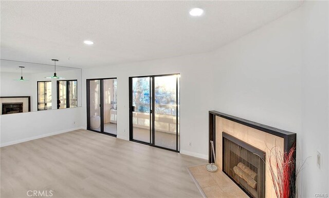 460 Oak St Unit 201, Glendale, CA 91204 - unfurnished living room featuring a fireplace, light wood-type flooring, baseboards, and recessed lighting