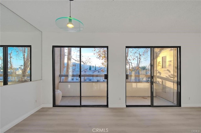 460 Oak St Unit 201, Glendale, CA 91204 - unfurnished dining area with wood finished floors, baseboards, and a textured ceiling