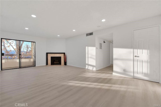 460 Oak St Unit 201, Glendale, CA 91204 - unfurnished living room featuring light wood finished floors, recessed lighting, baseboards, and a fireplace with flush hearth