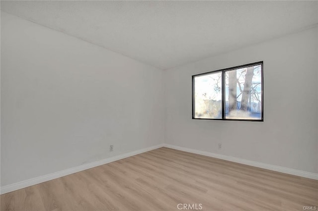 spare room with light hardwood / wood-style floors