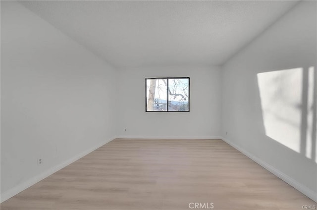 spare room featuring light hardwood / wood-style flooring