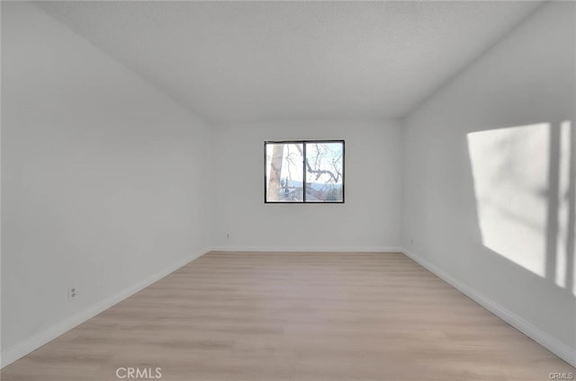460 Oak St Unit 201, Glendale, CA 91204 - unfurnished room with light wood-type flooring, vaulted ceiling, and baseboards