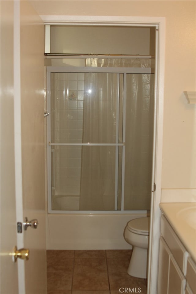 full bathroom with shower / bath combination with glass door, vanity, tile patterned floors, and toilet