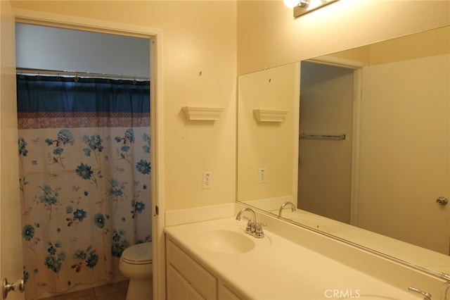 bathroom featuring tile patterned floors, vanity, toilet, and curtained shower