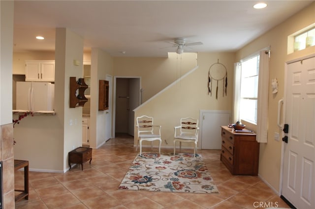 tiled foyer with ceiling fan