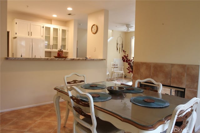 dining room with ceiling fan and light tile patterned flooring