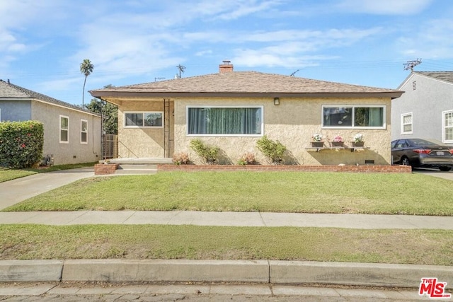 bungalow-style home with a front lawn