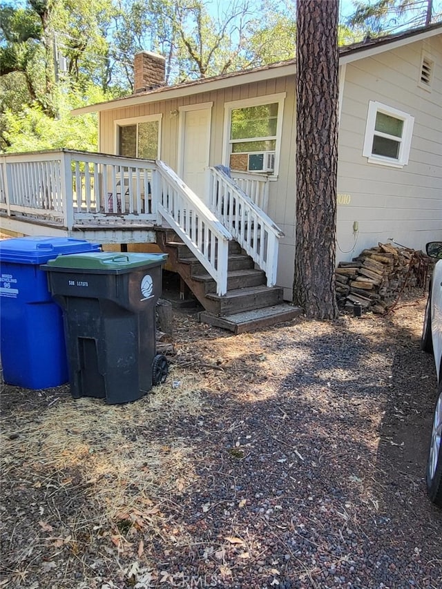 rear view of property with a wooden deck