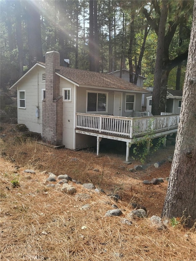 rear view of property featuring a deck