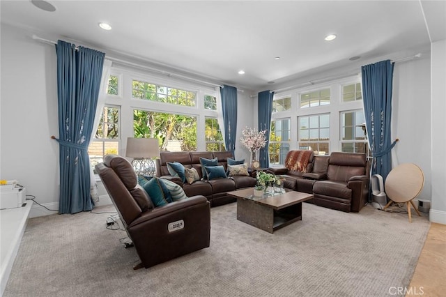 living area featuring baseboards and recessed lighting