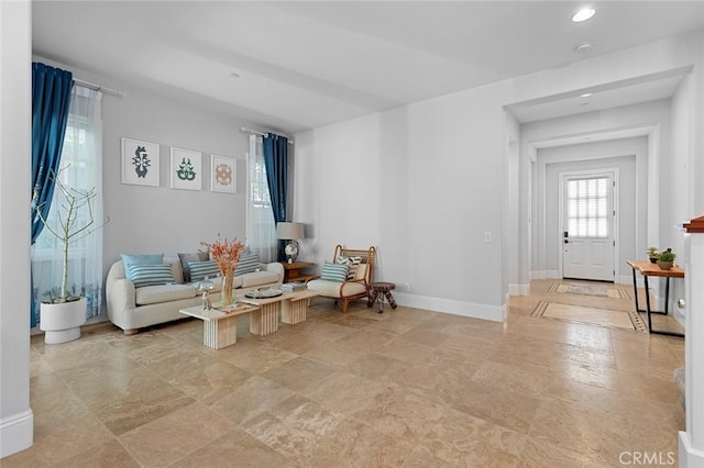 living area with recessed lighting and baseboards