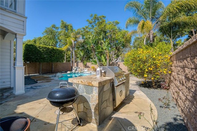 view of patio featuring a fenced in pool, a fenced backyard, grilling area, and area for grilling