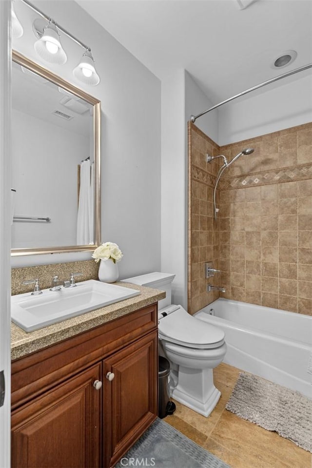 bathroom featuring shower / tub combo, visible vents, vanity, and toilet