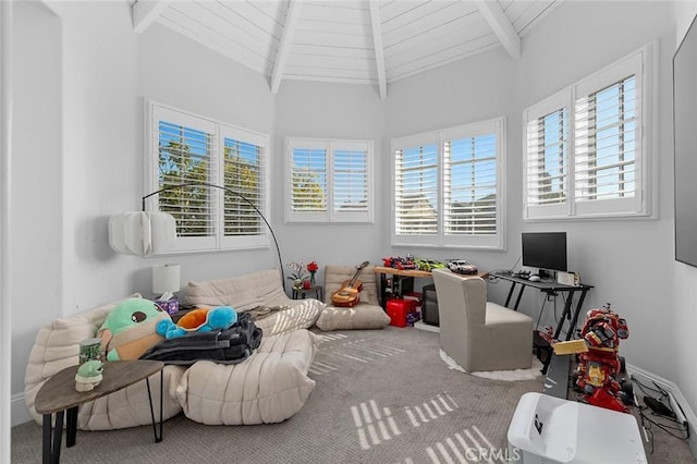 playroom featuring lofted ceiling with beams, carpet, plenty of natural light, and wooden ceiling