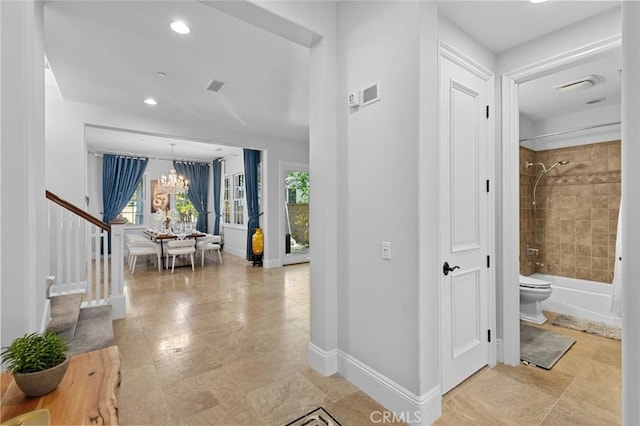 hall featuring visible vents, baseboards, stairs, a chandelier, and recessed lighting