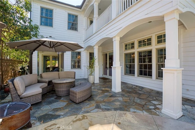 view of patio featuring a balcony and an outdoor living space