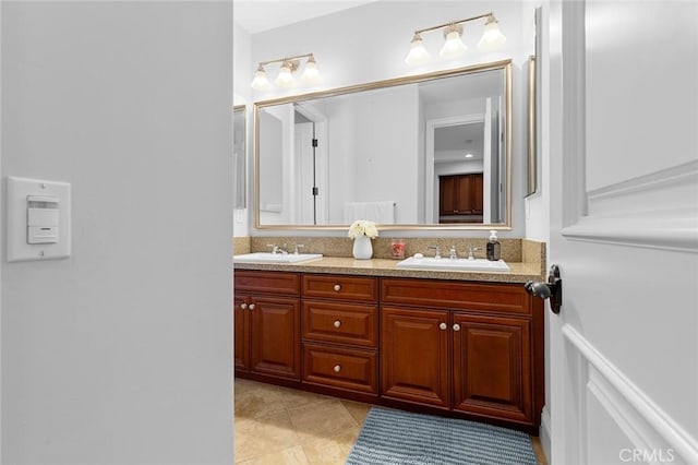 bathroom featuring tile patterned floors, a sink, and double vanity