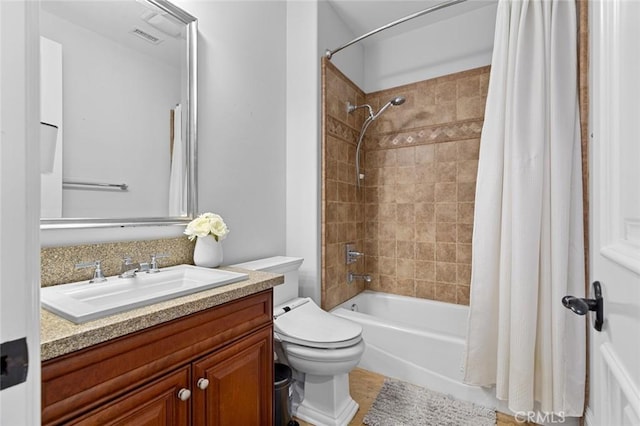 bathroom featuring visible vents, shower / bath combo, vanity, and toilet