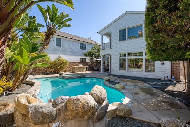 view of pool featuring a pool with connected hot tub and a patio area