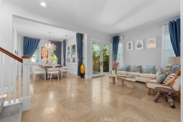 living area featuring an inviting chandelier, baseboards, and recessed lighting