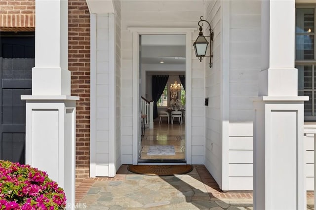doorway to property featuring brick siding