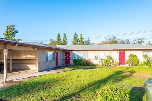 single story home with a front lawn and a carport