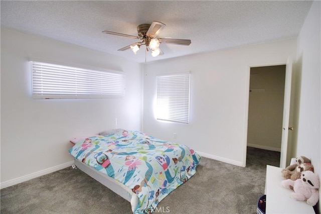 bedroom featuring ceiling fan, carpet flooring, and a textured ceiling