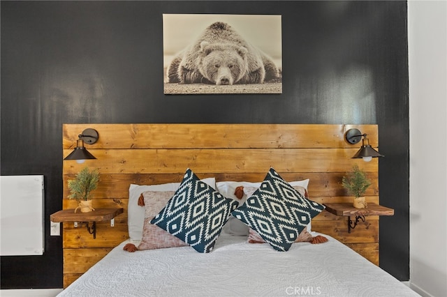 bedroom featuring wood walls