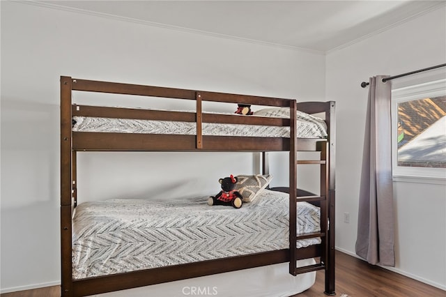 bedroom featuring wood-type flooring and ornamental molding