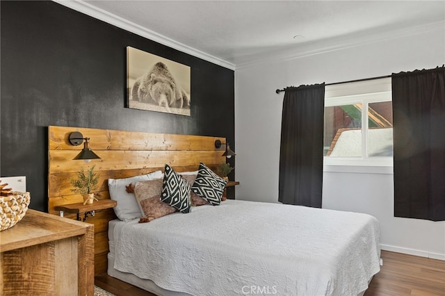 bedroom featuring ornamental molding and hardwood / wood-style floors