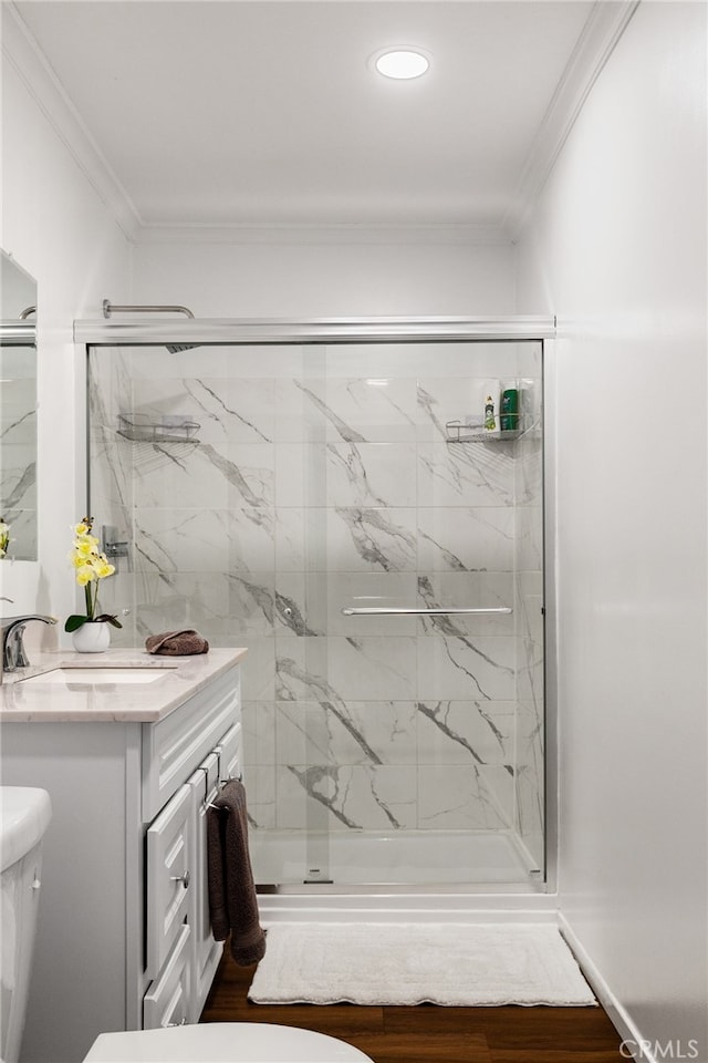 bathroom with vanity, crown molding, toilet, and an enclosed shower