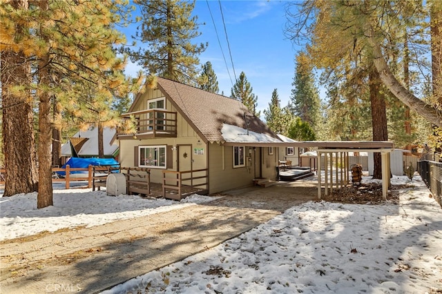 view of front of house featuring a deck and a carport