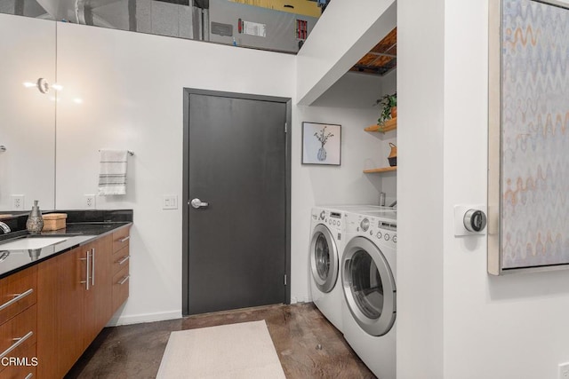 clothes washing area featuring sink and separate washer and dryer