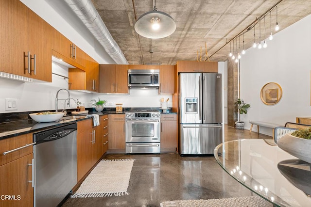 kitchen with decorative light fixtures, appliances with stainless steel finishes, and sink