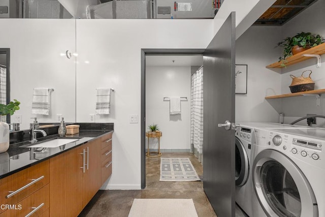 laundry area with washing machine and dryer and sink