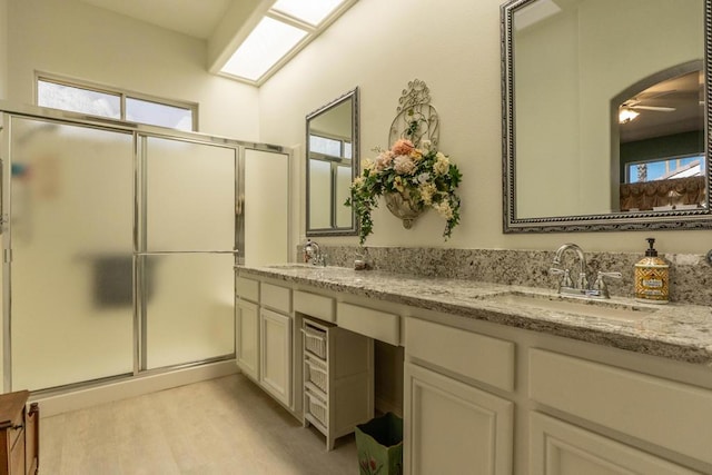 bathroom with an enclosed shower, vanity, and ceiling fan