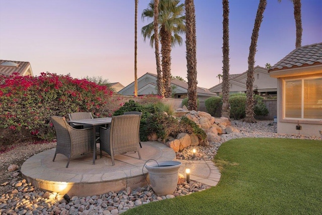 patio terrace at dusk with a yard