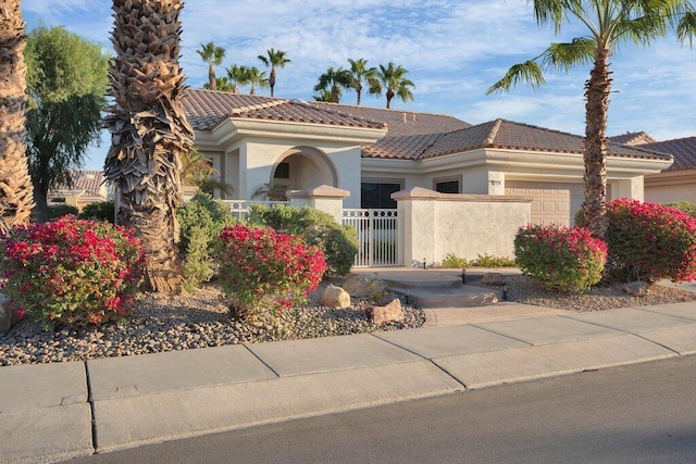 mediterranean / spanish house with a garage