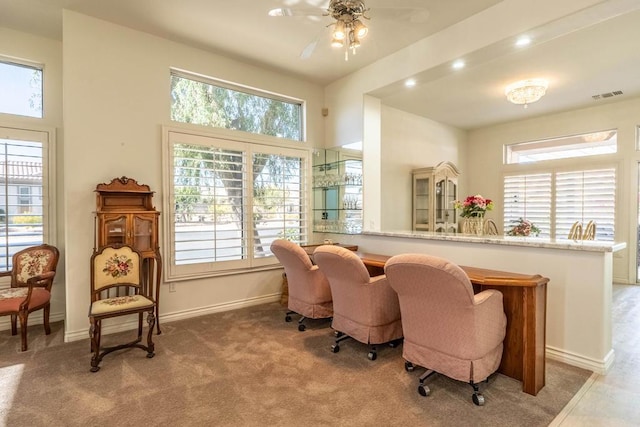 sitting room featuring ceiling fan and carpet