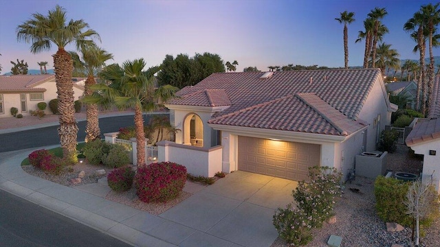 mediterranean / spanish house with a garage