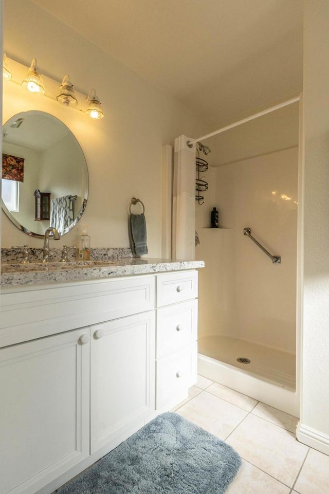 bathroom featuring a shower with shower curtain, vanity, and tile patterned floors