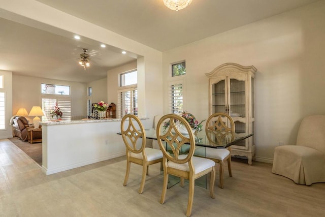 dining space featuring ceiling fan and light wood-type flooring