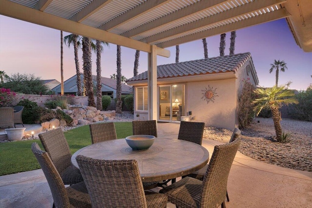 patio terrace at dusk with a pergola