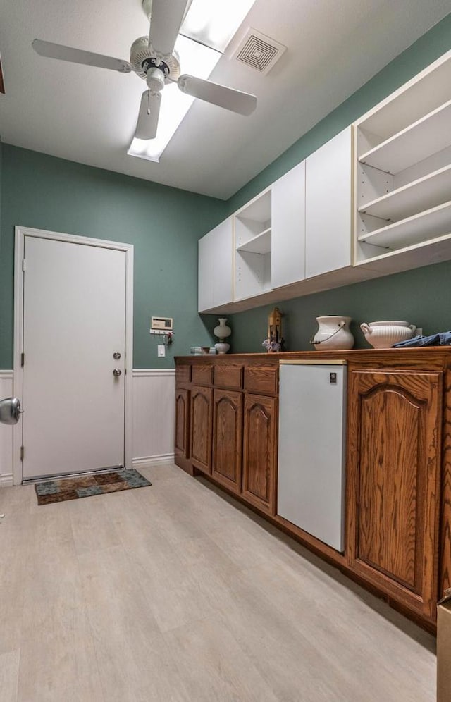 washroom featuring ceiling fan and light wood-type flooring