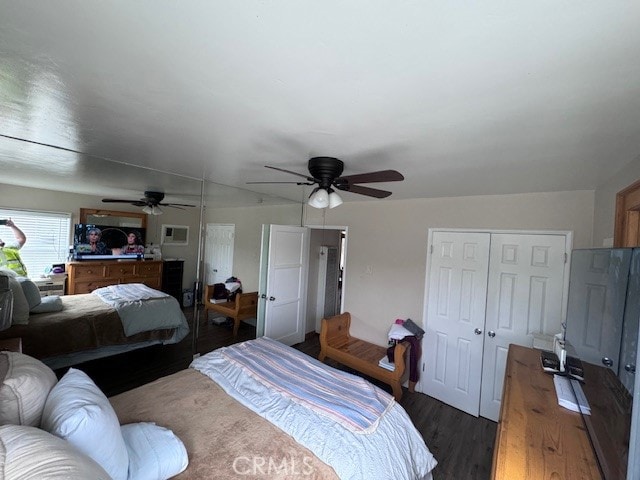 bedroom featuring dark hardwood / wood-style flooring, lofted ceiling, and ceiling fan