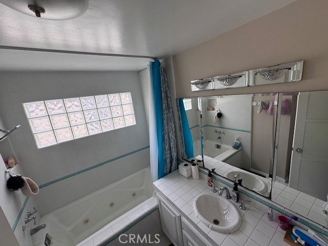 bathroom featuring vanity, a relaxing tiled tub, tile patterned floors, and vaulted ceiling