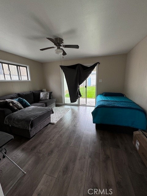 bedroom featuring dark hardwood / wood-style flooring, access to exterior, and ceiling fan