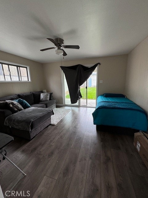 bedroom featuring dark wood-type flooring, ceiling fan, and access to outside