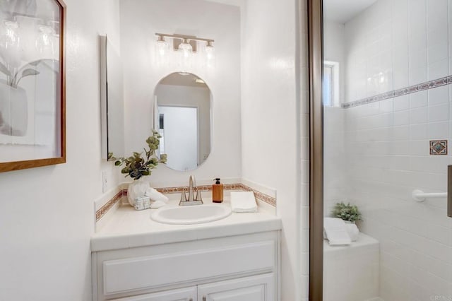 bathroom featuring an enclosed shower and vanity