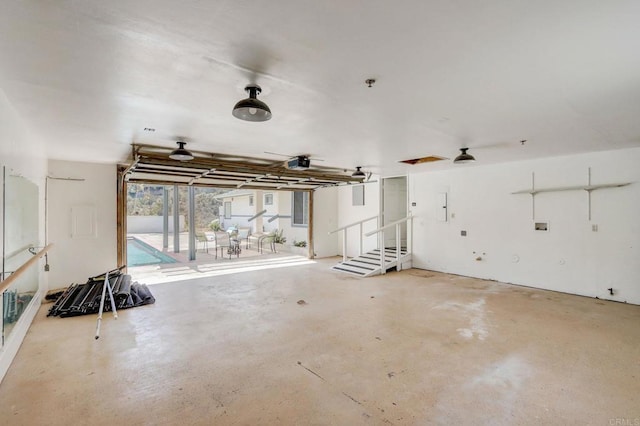 garage featuring a garage door opener, electric panel, a swimming pool, and ceiling fan